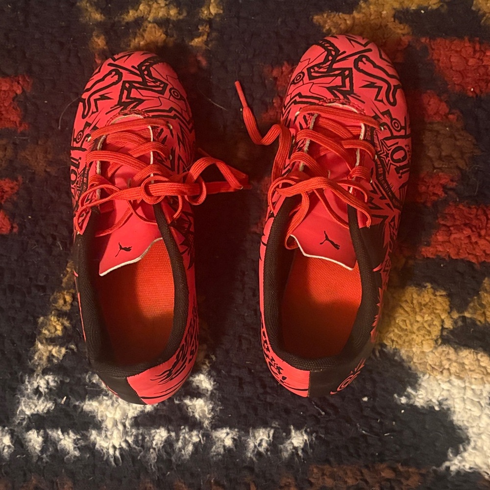Red graphic puma cleats